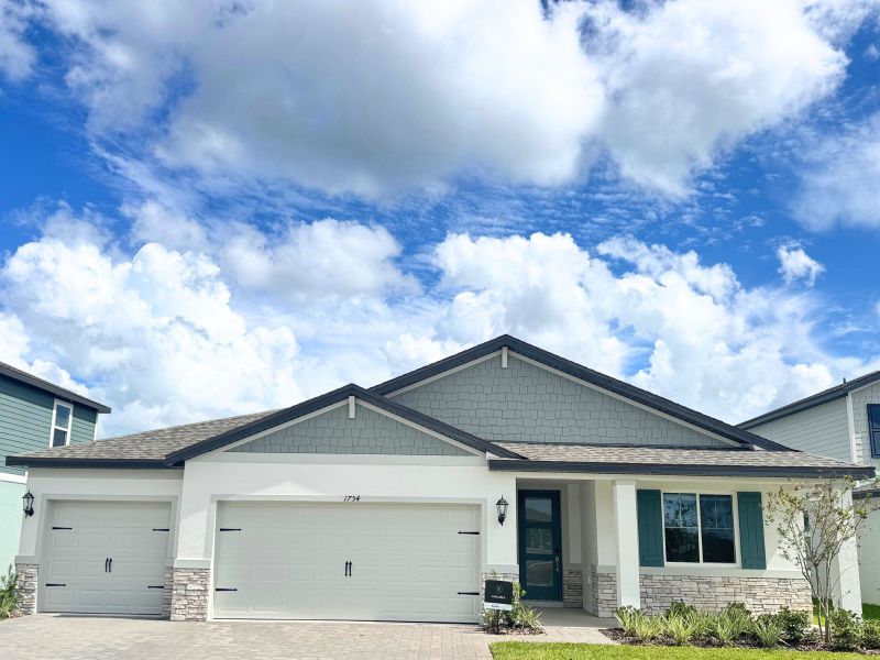 Front exterior of a new home in Two Rivers - Signature Series, Zephyrhills, FL, highlighting curb appeal (Image 2). Front exterior of a new home in Two Rivers - Signature Series, Zephyrhills, FL, highlighting curb appeal (Image 2).