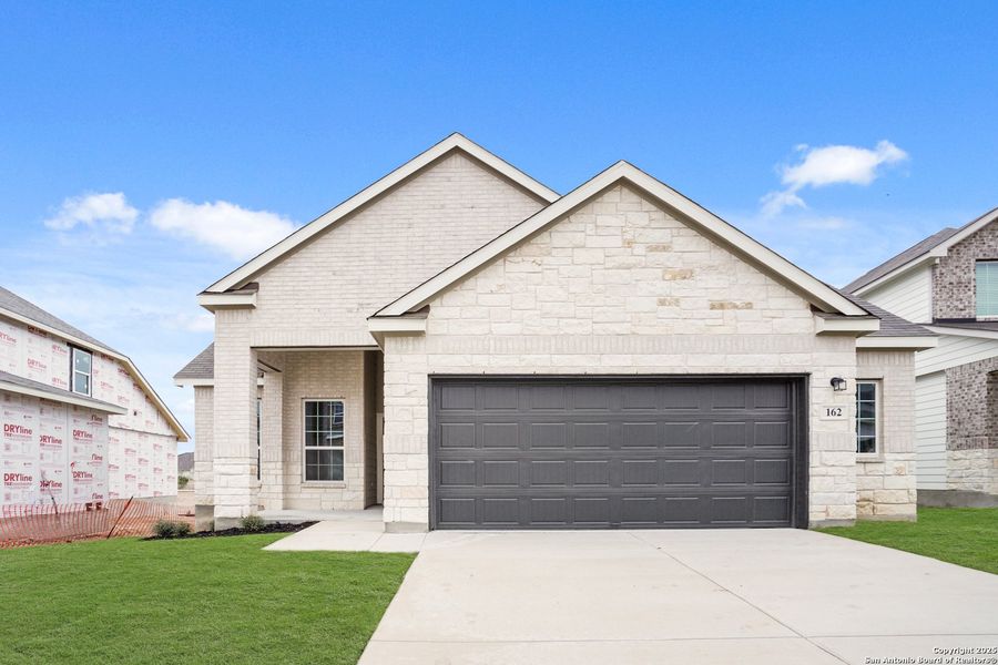 Front exterior of a new home in Hunters Ranch, San Antonio, TX, highlighting curb appeal (Image 1). Front exterior of a new home in Hunters Ranch, San Antonio, TX, highlighting curb appeal (Image 1).