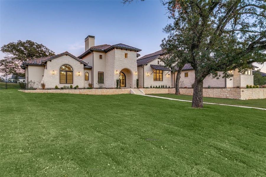 Elegant front elevation with stone and stucco exterior. Large front yard and home is set up on a hill which offers great views.