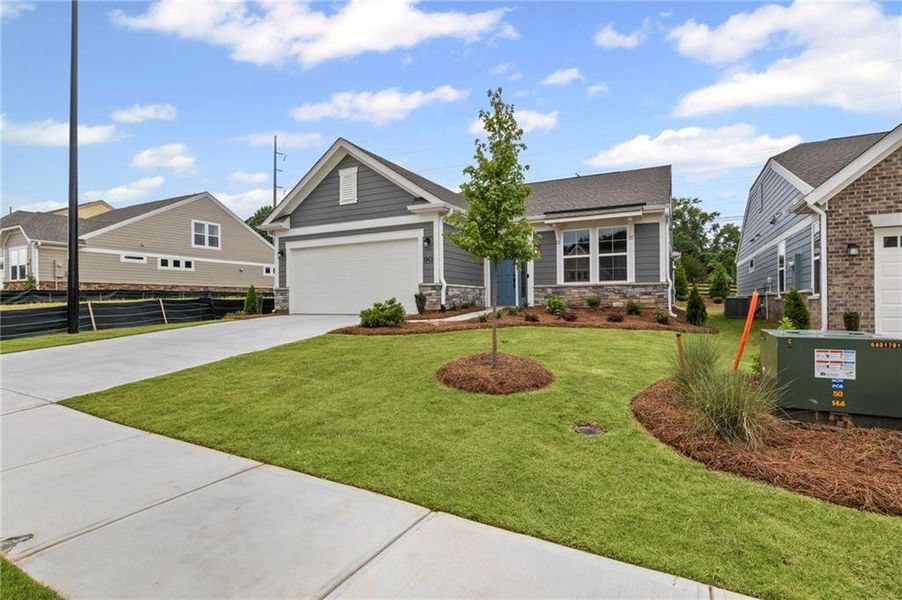 Front exterior of a new home in Laurel Farms, Dallas, GA, highlighting curb appeal (Image 23). Front exterior of a new home in Laurel Farms, Dallas, GA, highlighting curb appeal (Image 23).