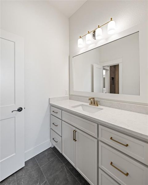 Bathroom with vanity and baseboards