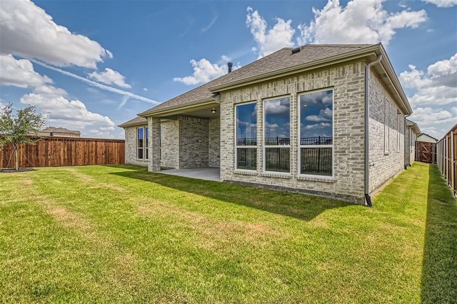 Back of house featuring a patio and a lawn