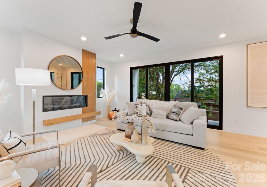 Open living area with electric fireplace.