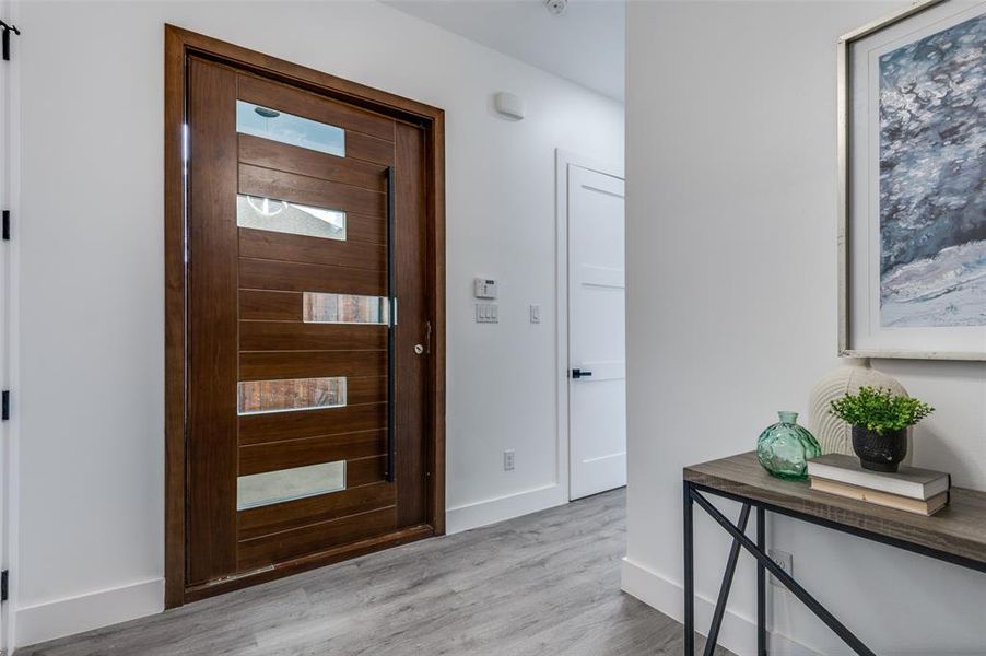 Foyer with light hardwood / wood-style floors