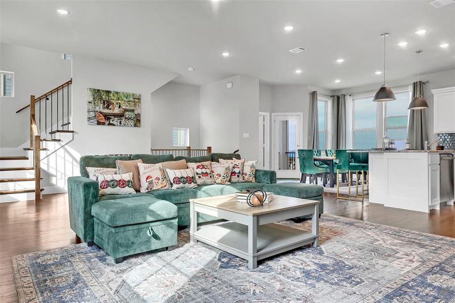 Living area with wood finished floors and recessed lighting