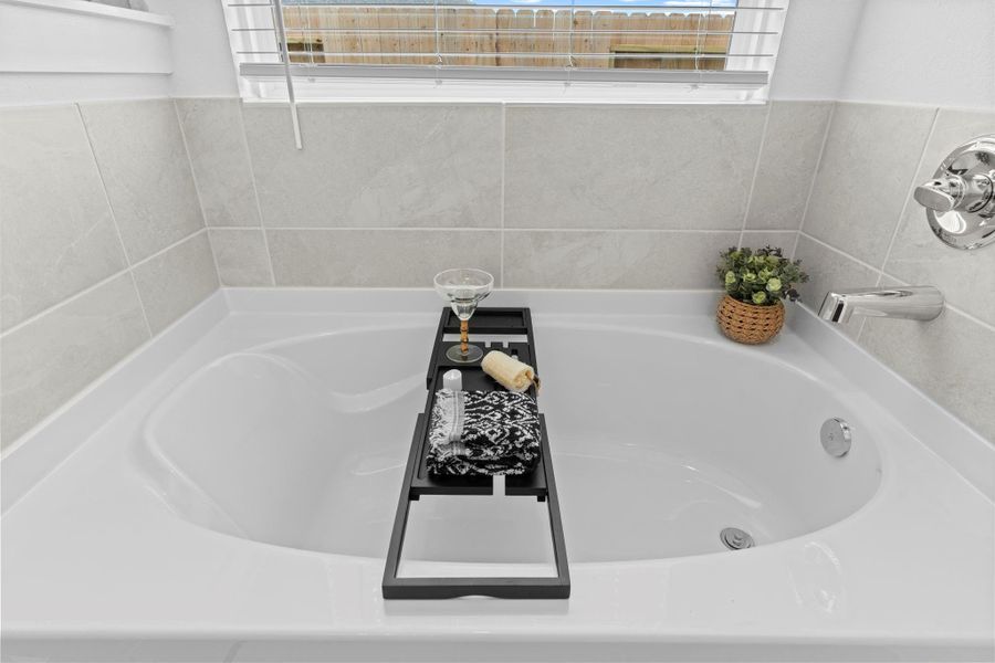 A closer view of the soaking tub reveals its spacious design and spa-like setting, complete with chrome fixtures and decorative touches for a true in-home escape. Bubble away that stress! A closer view of the soaking tub reveals its spacious design and spa-like setting, complete with chrome fixtures and decorative touches for a true in-home escape. Bubble away that stress!