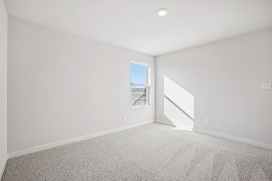 A room with a window and a bed.