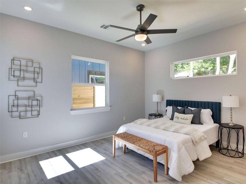 Bedroom with light wood-type flooring, recessed lighting, and ceiling fan