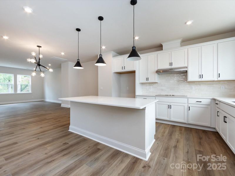 Gourmet Layout Kitchen with Designer Pendant Lighting.