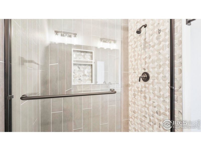 Walk-in shower w/floor to ceiling tile in primary bathroom Walk-in shower w/floor to ceiling tile in primary bathroom