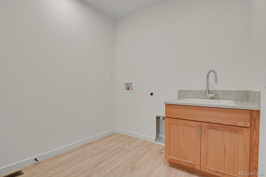 Large main level laundry room with sink and extra storage Large main level laundry room with sink and extra storage