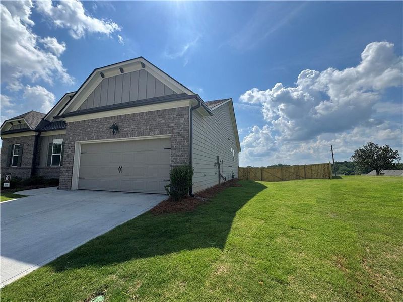 Front exterior of a new home in Rosewood Lake Preserve, Hoschton, GA, highlighting curb appeal (Image 16).