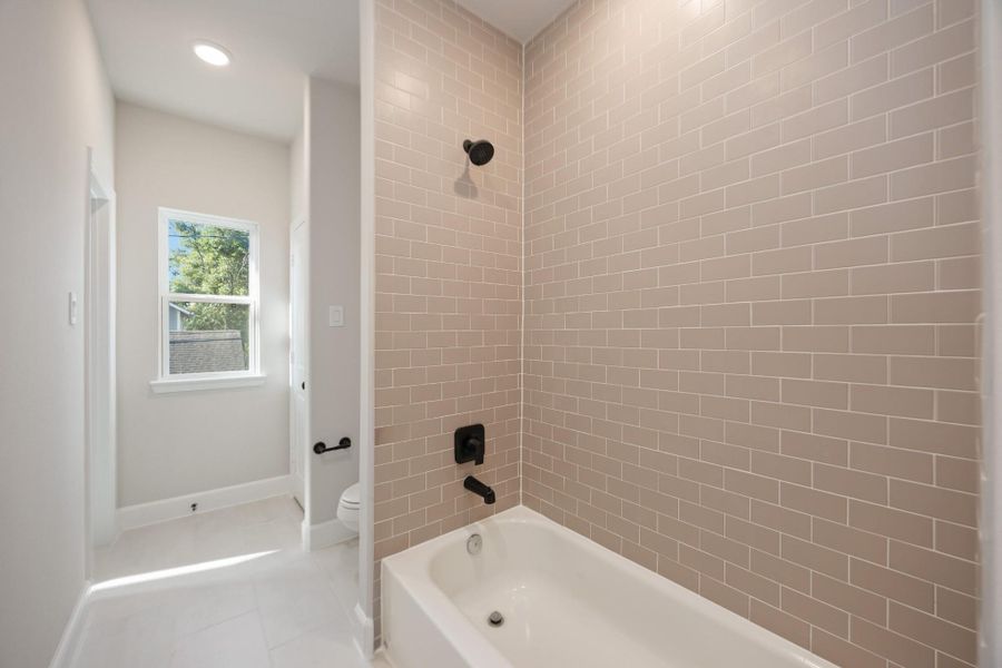 Flooded with light and finished with care, this hall bath delivers both function and finesse. Bonus points for that deep tub and elevated tilework. Flooded with light and finished with care, this hall bath delivers both function and finesse. Bonus points for that deep tub and elevated tilework.