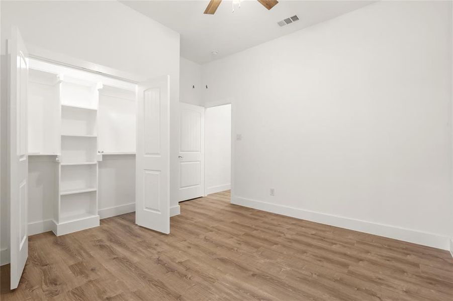 Unfurnished bedroom featuring light hardwood / wood-style floors and ceiling fan