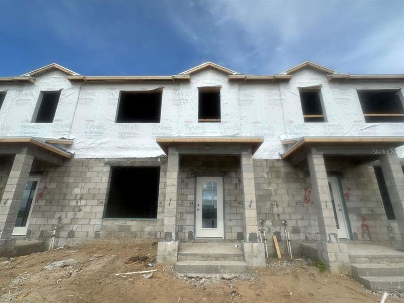 Front exterior of a new home in Tribute at Ovation, Winter Garden, FL, highlighting curb appeal (Image 22). Front exterior of a new home in Tribute at Ovation, Winter Garden, FL, highlighting curb appeal (Image 22).