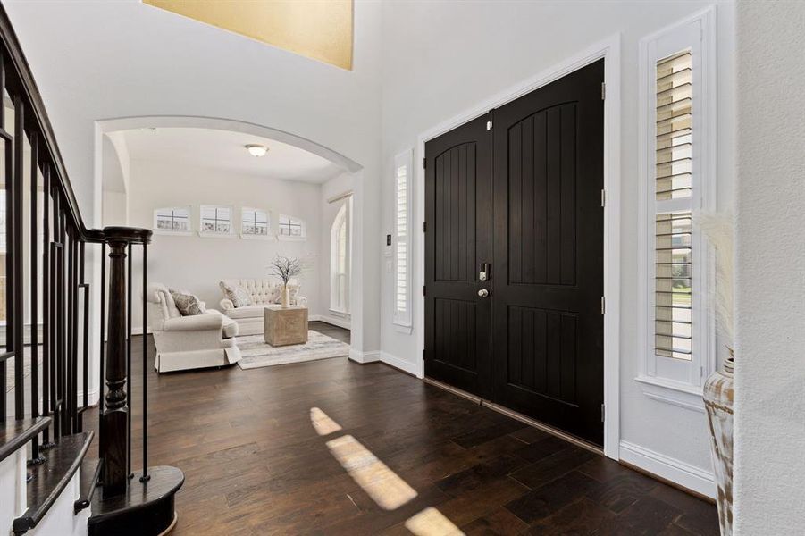 Foyer with dark hardwood / wood-style flooring