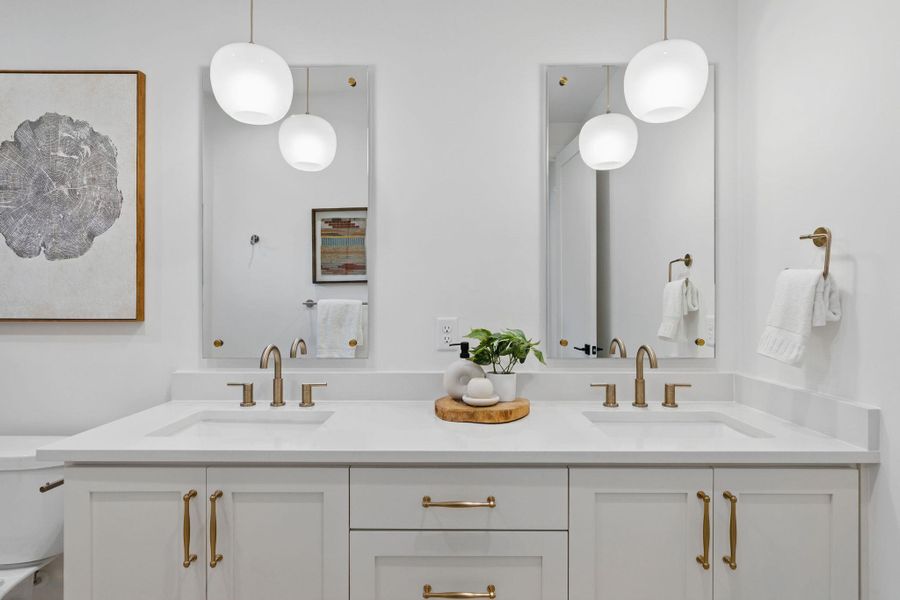 Full bathroom with double vanity and toilet