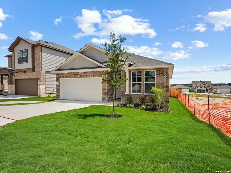 Front exterior of a new home in Hunter's Ranch, San Antonio, TX, highlighting curb appeal (Image 14). Front exterior of a new home in Hunter's Ranch, San Antonio, TX, highlighting curb appeal (Image 14).