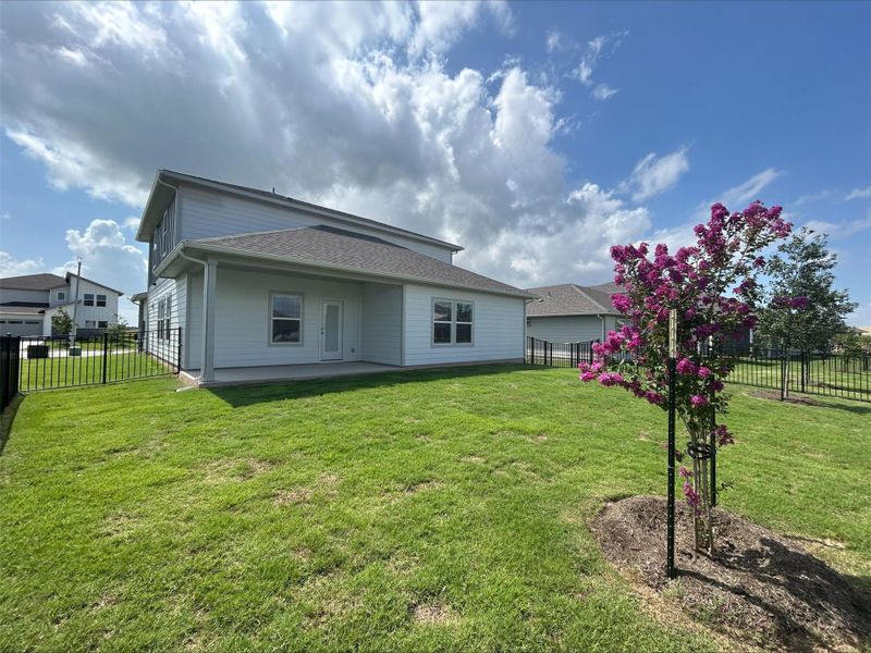 Rear view of house with a fenced backyard and a patio Rear view of house with a fenced backyard and a patio