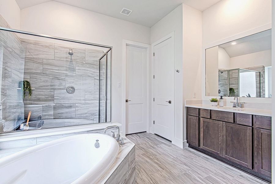 A close-up of the spa-like shower and oversized soaking tub, perfect for unwinding after a long day. A close-up of the spa-like shower and oversized soaking tub, perfect for unwinding after a long day.