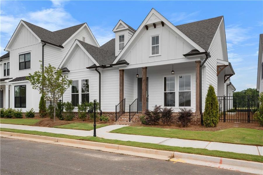 Front exterior of a new home in Promenade at Sawnee Village, Cumming, GA, highlighting curb appeal (Image 25). Front exterior of a new home in Promenade at Sawnee Village, Cumming, GA, highlighting curb appeal (Image 25).