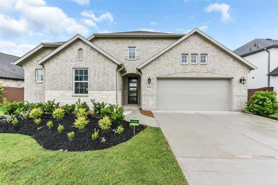 Front exterior of a new home in Evergreen 55', Conroe, TX, highlighting curb appeal (Image 2).