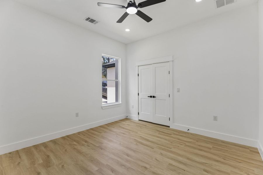 Warm wood flooring and clean lines define this versatile secondary space.