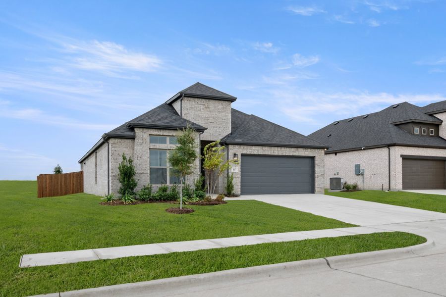 Front exterior of a new home in Vista Point, Grandview, TX, highlighting curb appeal (Image 2). Front exterior of a new home in Vista Point, Grandview, TX, highlighting curb appeal (Image 2).