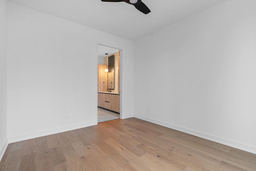Unfurnished room with light wood finished floors and a ceiling fan