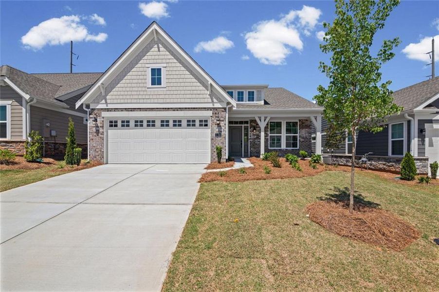 Front exterior of a new home in Laurel Farms, Dallas, GA, highlighting curb appeal (Image 17). Front exterior of a new home in Laurel Farms, Dallas, GA, highlighting curb appeal (Image 17).