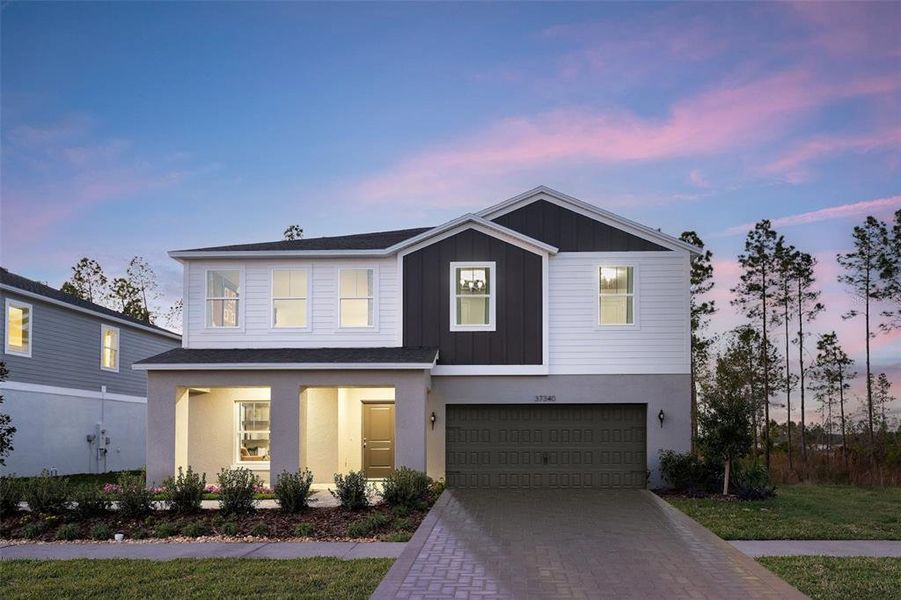 Front exterior of a new home in Two Rivers, Zephyrhills, FL, highlighting curb appeal (Image 1).