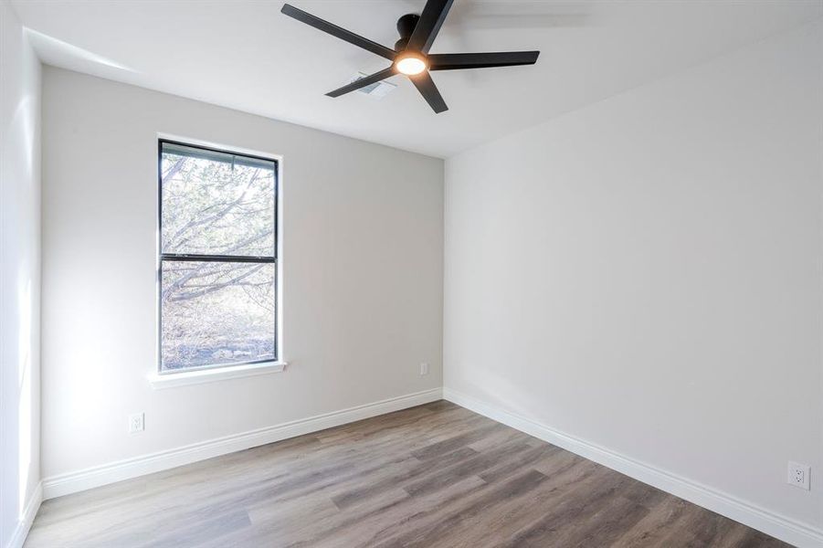 Bedroom featuring ceiling fan and light wood-type flooring