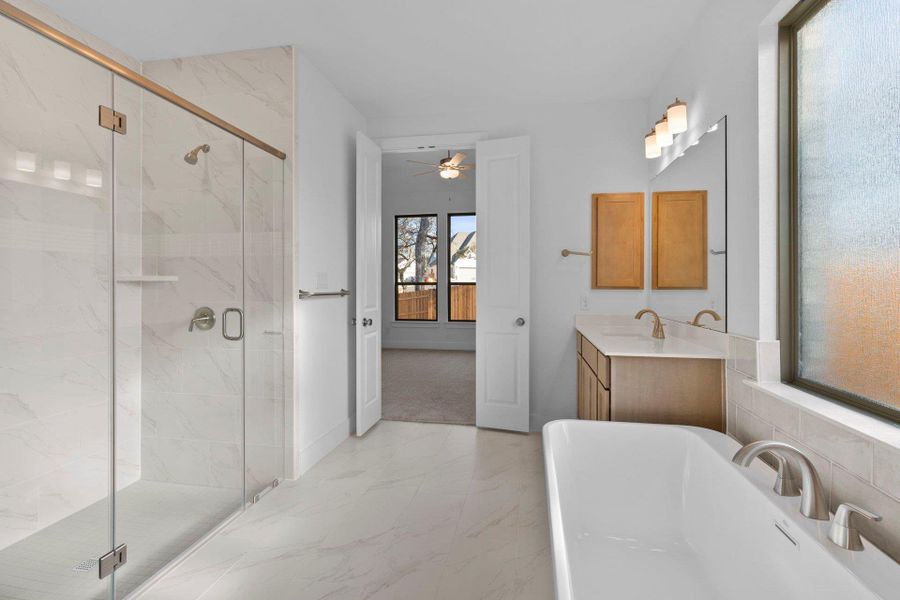 Primary Bath retreat with dual vanities, soaking tub & walk-in shower Primary Bath retreat with dual vanities, soaking tub & walk-in shower