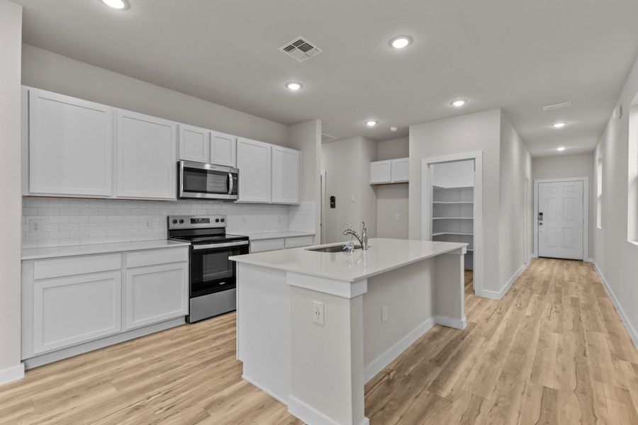 A kitchen with white cabinets. A kitchen with white cabinets.