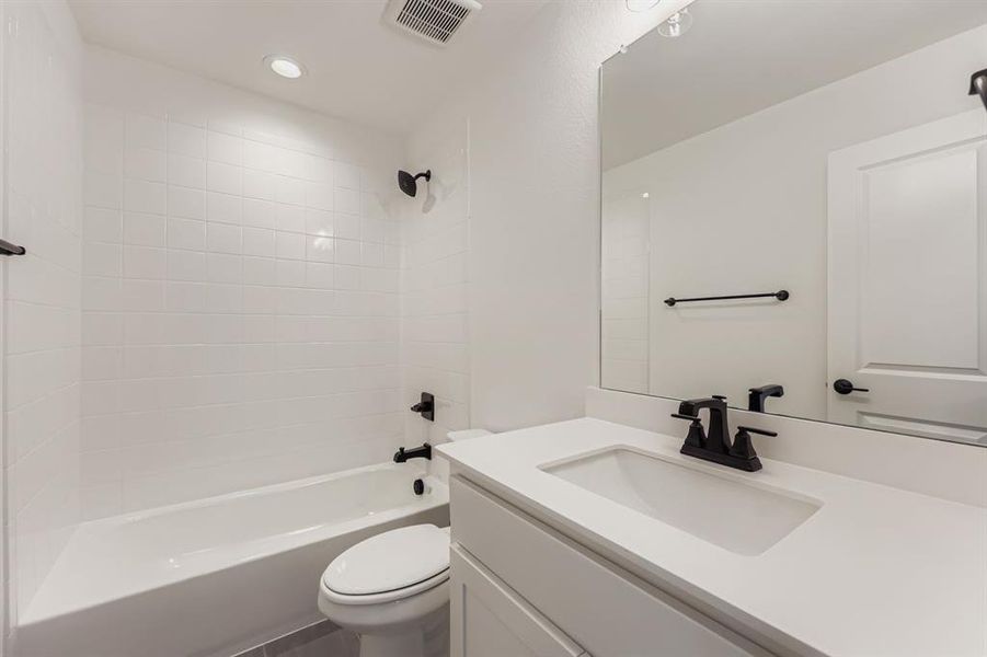 Full bath with tub / shower combination, vanity, and recessed lighting