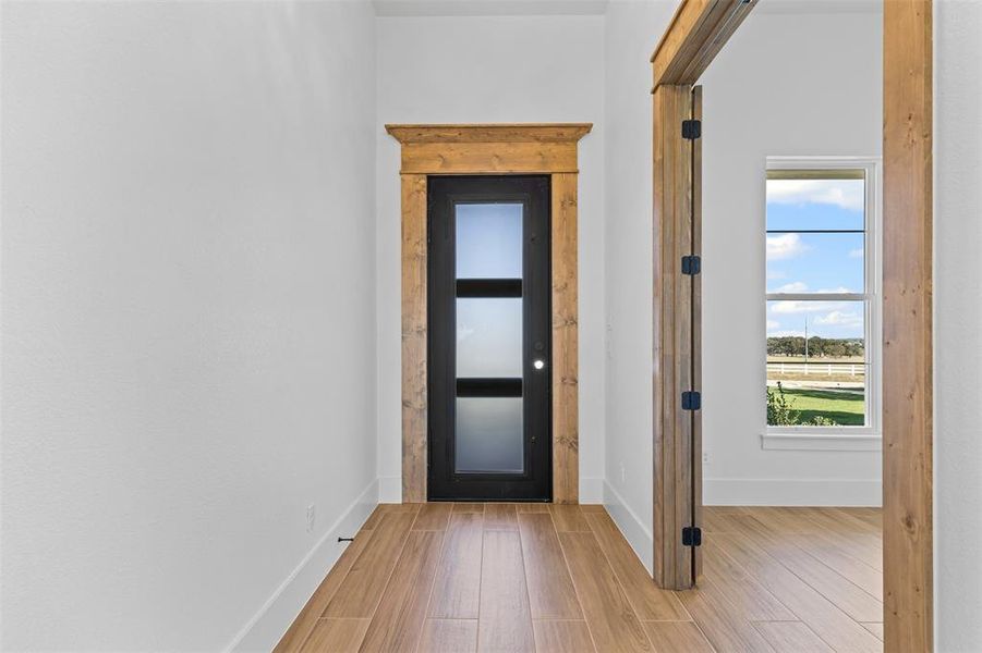 Doorway to outside featuring wood finished floors and baseboards