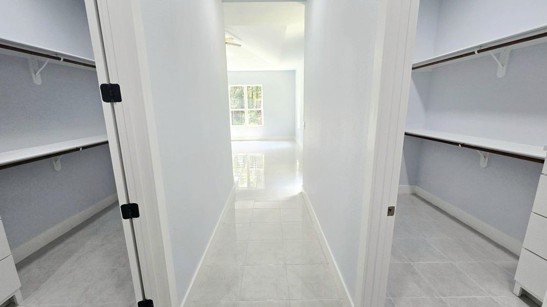 primary bedroom his and her walking closet primary bedroom his and her walking closet