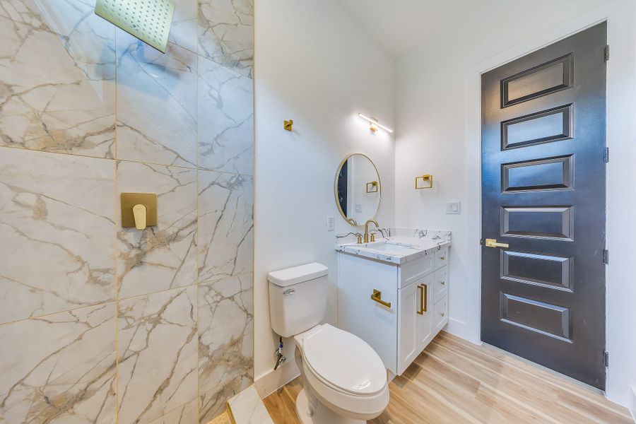 Second bathroom features stylish black and gold touches, adding elegance and a modern, luxurious feel to the space.