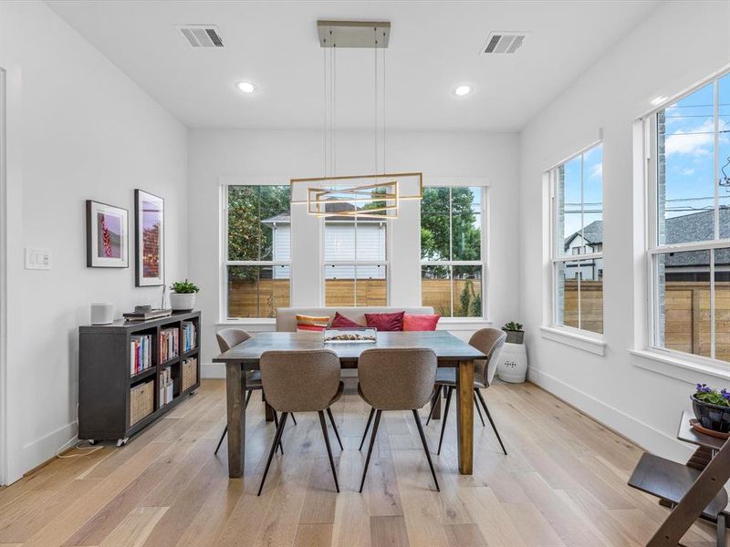 A lovely dining room overflowing with copious natural light makes a wonderful space where memories will be made and shared over the years.