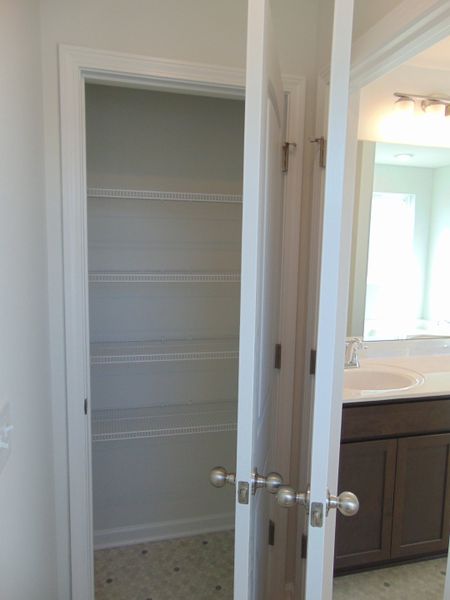 The linen closet within the primary bathroom