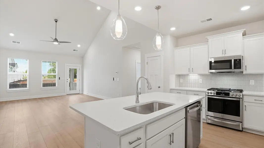 Exceptional kitchen featuring a center island, eye-catching pendant lights, and modern finishes near Lake Hartwell