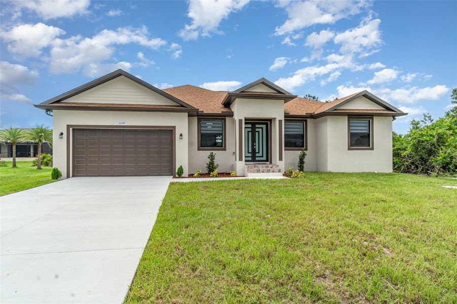 Front exterior of a new home in , Port Charlotte, FL, highlighting curb appeal (Image 1). Front exterior of a new home in , Port Charlotte, FL, highlighting curb appeal (Image 1).