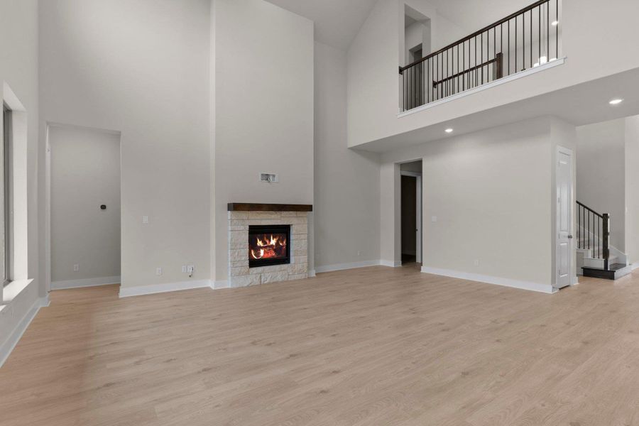Family Room with soaring ceiling & fireplace
