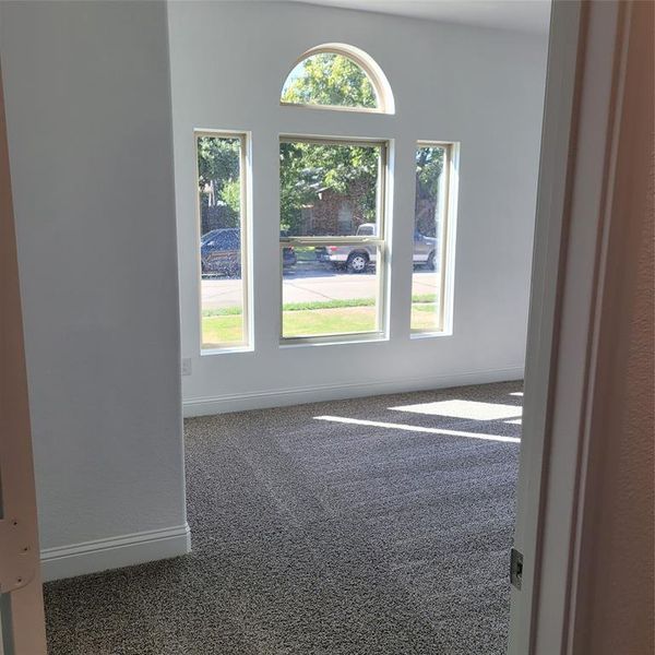 Carpeted spare room with plenty of natural light