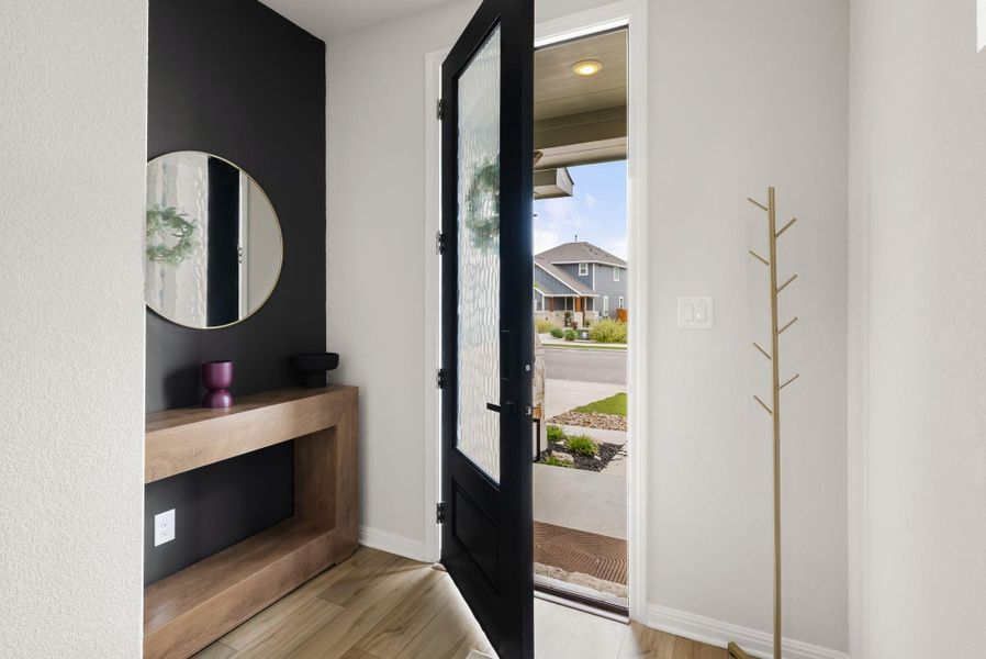Foyer entrance with light wood-style flooring