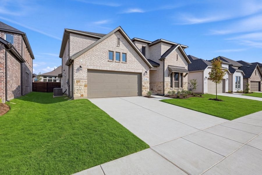 Front exterior of a new home in The Ridge at Northlake, Northlake, TX, highlighting curb appeal (Image 2). Front exterior of a new home in The Ridge at Northlake, Northlake, TX, highlighting curb appeal (Image 2).