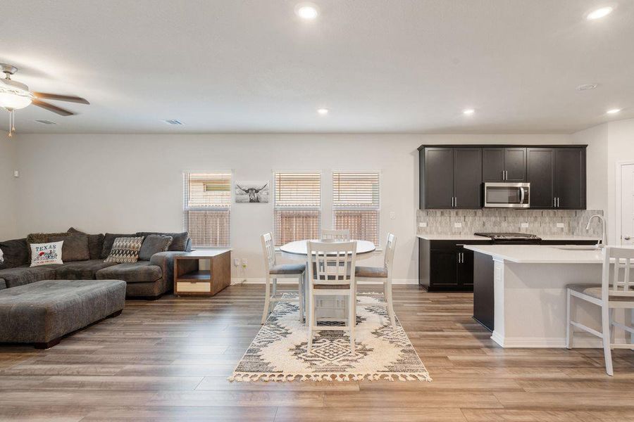 Open living and dining space with natural light from multiple windows and plenty of room for family gatherings. Open living and dining space with natural light from multiple windows and plenty of room for family gatherings.