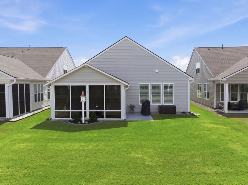 Exterior details and patio area of a home in K. Hovnanian's® Four Seasons at Lakes of Cane Bay, Summerville (Image 3).