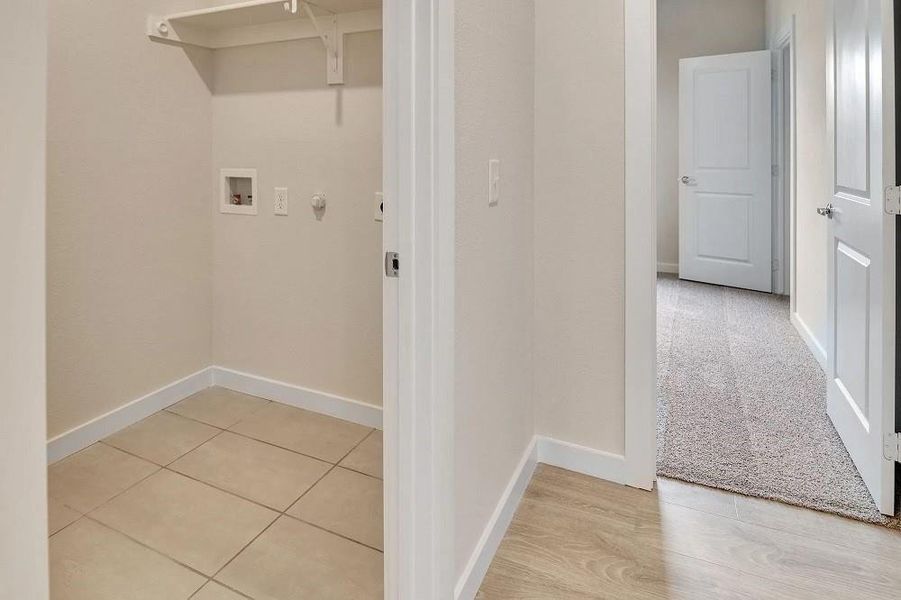 Laundry area featuring washer hookup and baseboards Laundry area featuring washer hookup and baseboards
