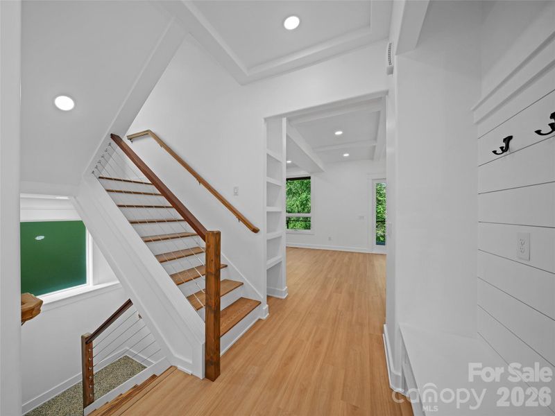 Main staircase with hall to great room main level windows to back yard.